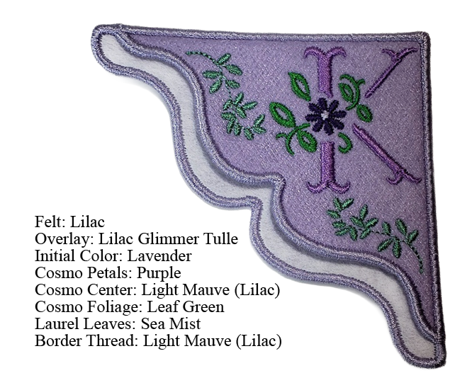 Lilac felt corner bookmark with lilac glimmer tulle overlay. Design features the initial K with a purple "Cosmo" flower with leaf green foliage. Mist green laural leaves align the curved border of the bookmark.  This corner bookmark fits nicely on the corner of a page of a book to mark the readers place.